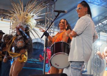Comparsas y bailarines de samba desfilan entre carrozas iluminadas durante las celebraciones del carnaval en Florianópolis.