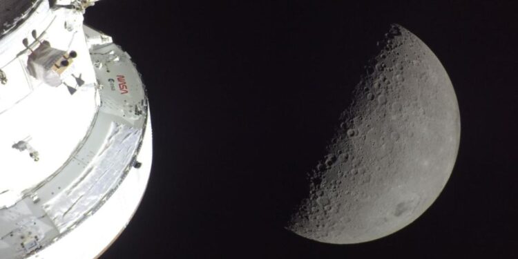 La nave espacial Orión se ve en primer plano, iluminada por el Sol. Detrás, la Luna.
