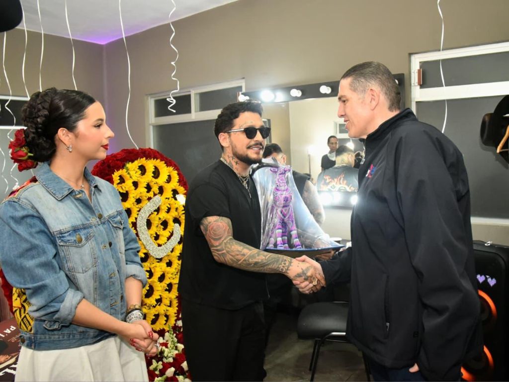 Christian Nodal y Ángela Aguilar reciben una escultura de El Venado en arte huichol de manos del alcalde Luis Mendoza previo a la presentación del cantante en la Plaza de Toros México.