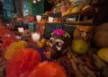 Altar de Día de Muertos con flores de cempasúchil, veladoras y pan de muerto en México.