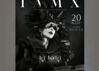 Chris Corner, líder de IAMX, durante una presentación en vivo con una puesta en escena de estética oscura, iluminación teatral y elementos audiovisuales.